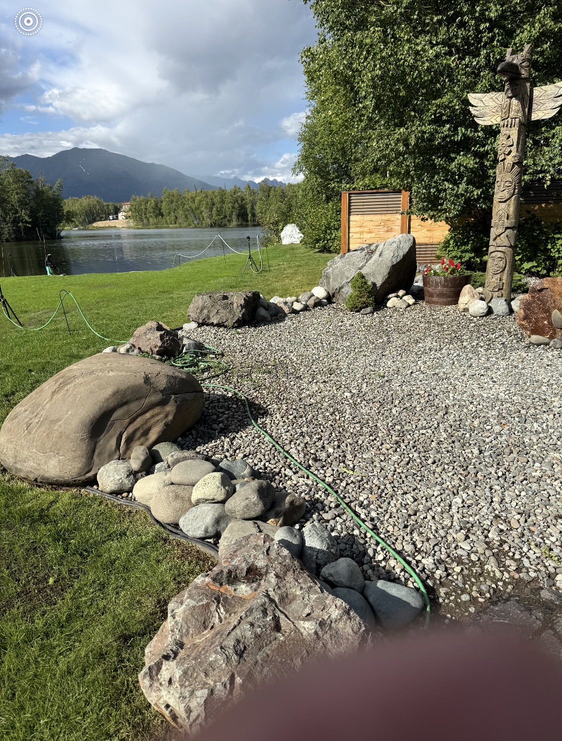 Completed gravel and boulder landscaping along a lakeshore — Mat-Su Valley, Alaska