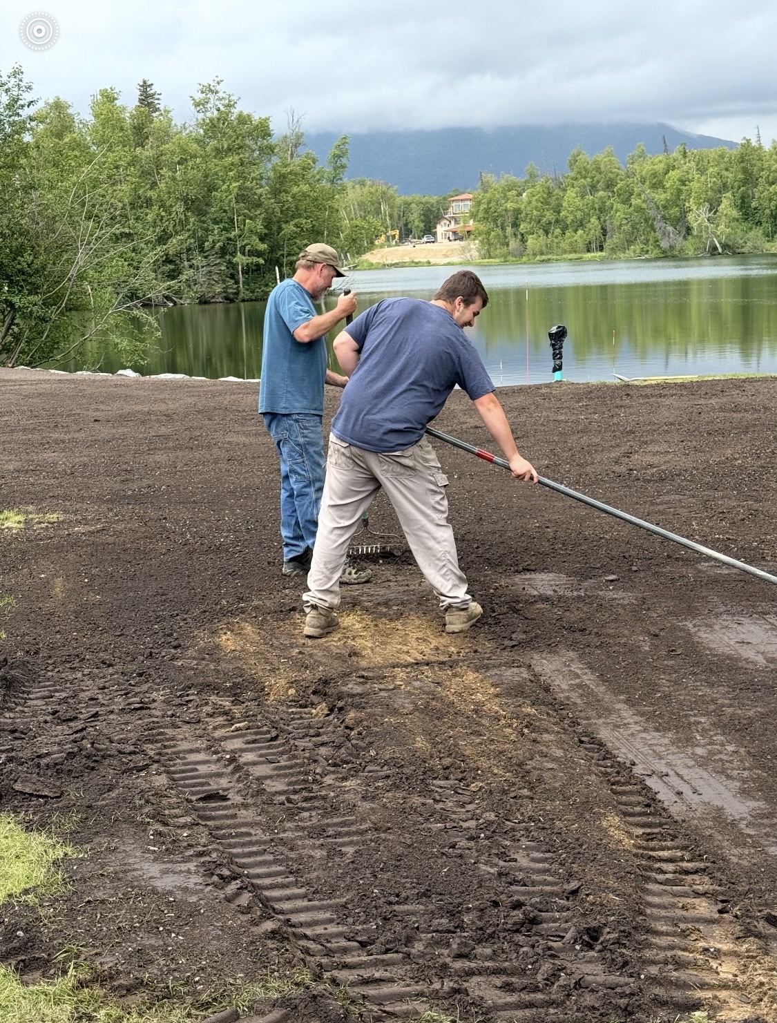 Wayne and crew doing final topsoil grading on a residential waterfront site in the Mat-Su Valley