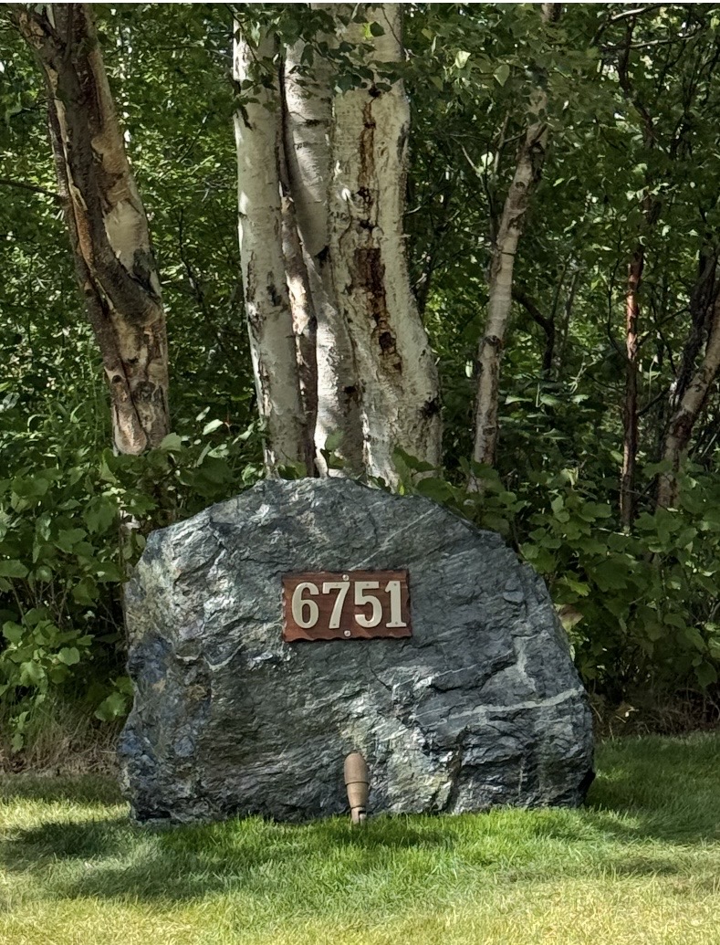 Large boulder with house address mounted as a finished address marker — landscaping detail, Mat-Su Valley